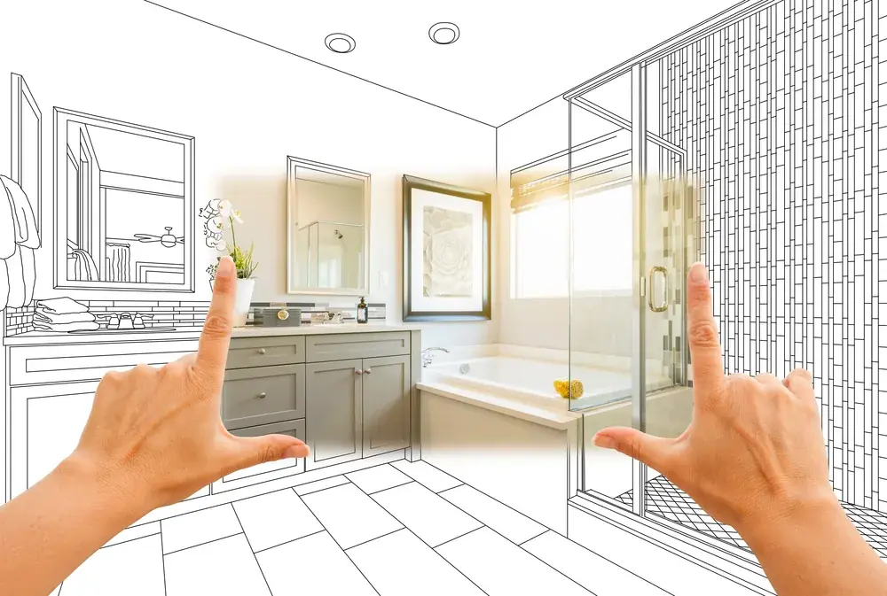 Hands framing a bathroom where a line drawing becomes a finished photograph