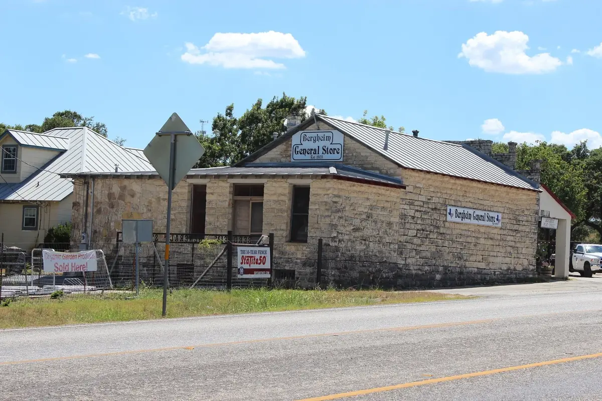 The Bergheim General Store seen from across State Highway 46, the highway empty in the foreground under a summer sky