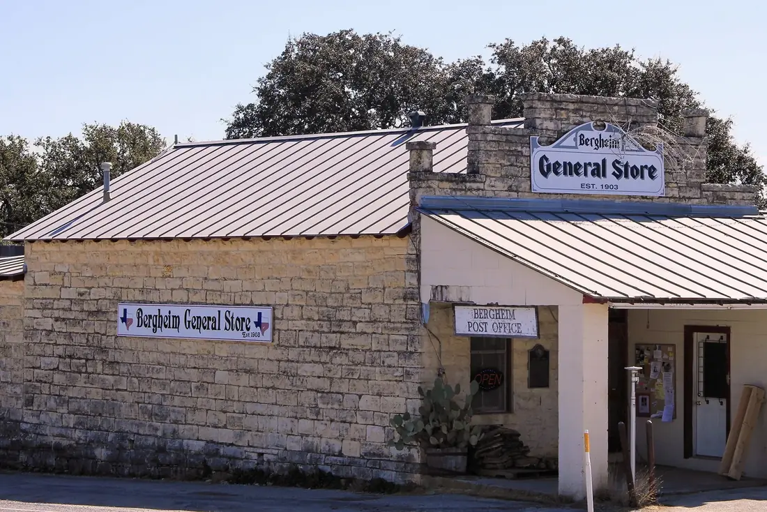 The limestone Bergheim General Store at the Highway 46 crossroads, the 1903 gable sign above the porch and the state marker out front