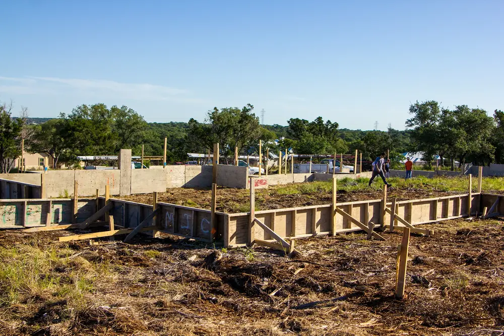 Foundation forms and plumbing rough-in on a Hill Country new construction site